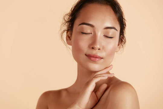 woman closing her eyes with makeup on