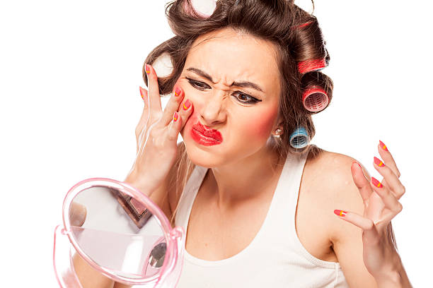 woman struggling to fix her makeup